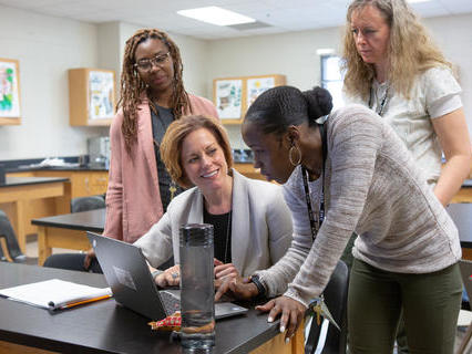 teachers looking at a computer